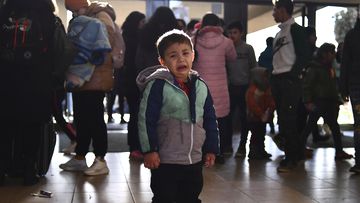 A refugee boy who fled conflict from neighboring Ukraine cries at the railway station after arriving to Zahony, Hungary, Sunday, Feb. 27, 2022. 