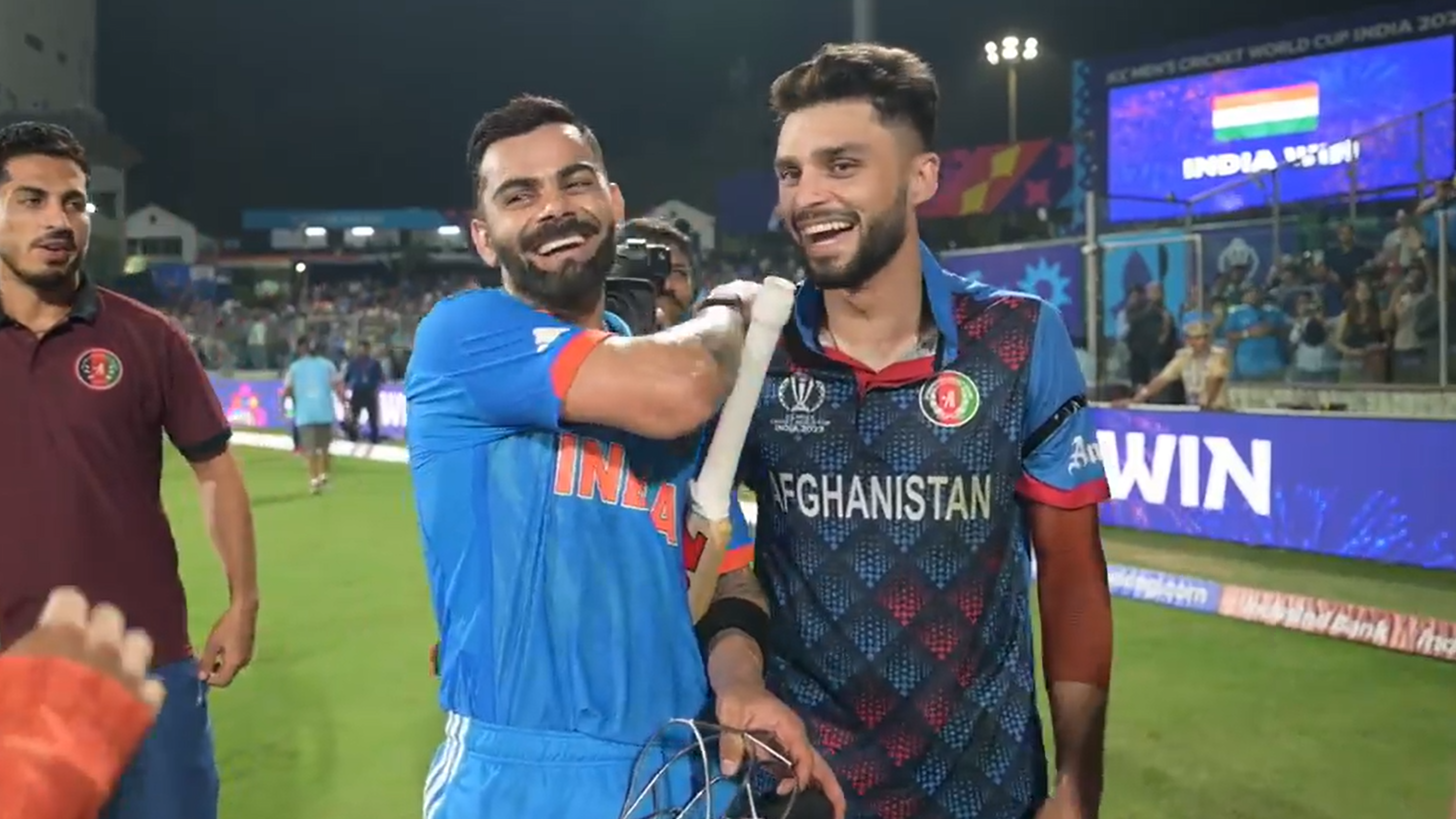 Virta Kohli (left) and Naveen-Al-Huq share a laugh after India&#x27;s win over Afghanistan.
