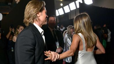 Brad Pitt is photographed grabbing Jennifer Aniston's hand as she walks away at the SAG awards.