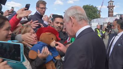 King Charles III with a Paddington Bear at the queue in London.