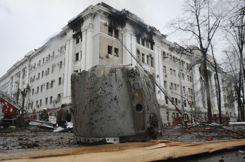 A rocket fragment lies on the ground next to a building of Ukrainian Security Service (SBU) after a rocket attack in Kharkiv, Ukraine's second-largest city, Ukraine, Wednesday, March 2, 2022. 