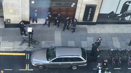 Armed police officers descended on the building in Kensington, central London, at about 11am on Friday local time and one man was arrested.