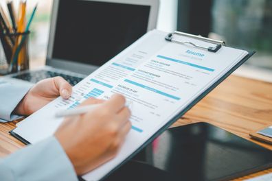 HR managers are interviewing job applicants who fill out their resume on the job application form in order to consider accepting a job as a company