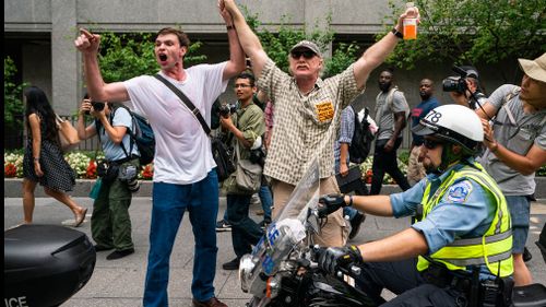 Hundreds of counter-protesters are walking alongside the group but keeping on the sidewalks, many of them shouting and taunting the nationalists as they make their way to a park in front of the White House.