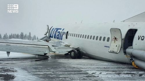 A plane carrying 94 people made an emergency landing in Russia after being hit by a wind shear. 