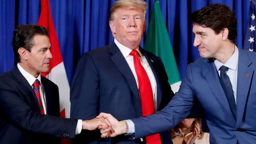 Mexican President Enrique Pena Neto, US President Donald Trump, and Canadian Prime Minister Justin Trudeau participate in the USMCA signing ceremony ahead of the G20 summit in Buenos Aires, Argentina.