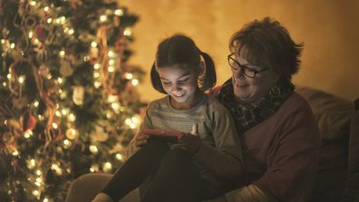 grandmother and granddaughter watching videos on smart phone