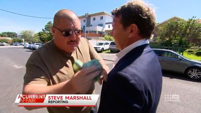 he shoved a fistful of hundred dollar bills into the top pocket of A Current Affair reporter Steve Marshall.