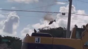 A helicopter is seen on fire before crashing into a unit block in Florida.