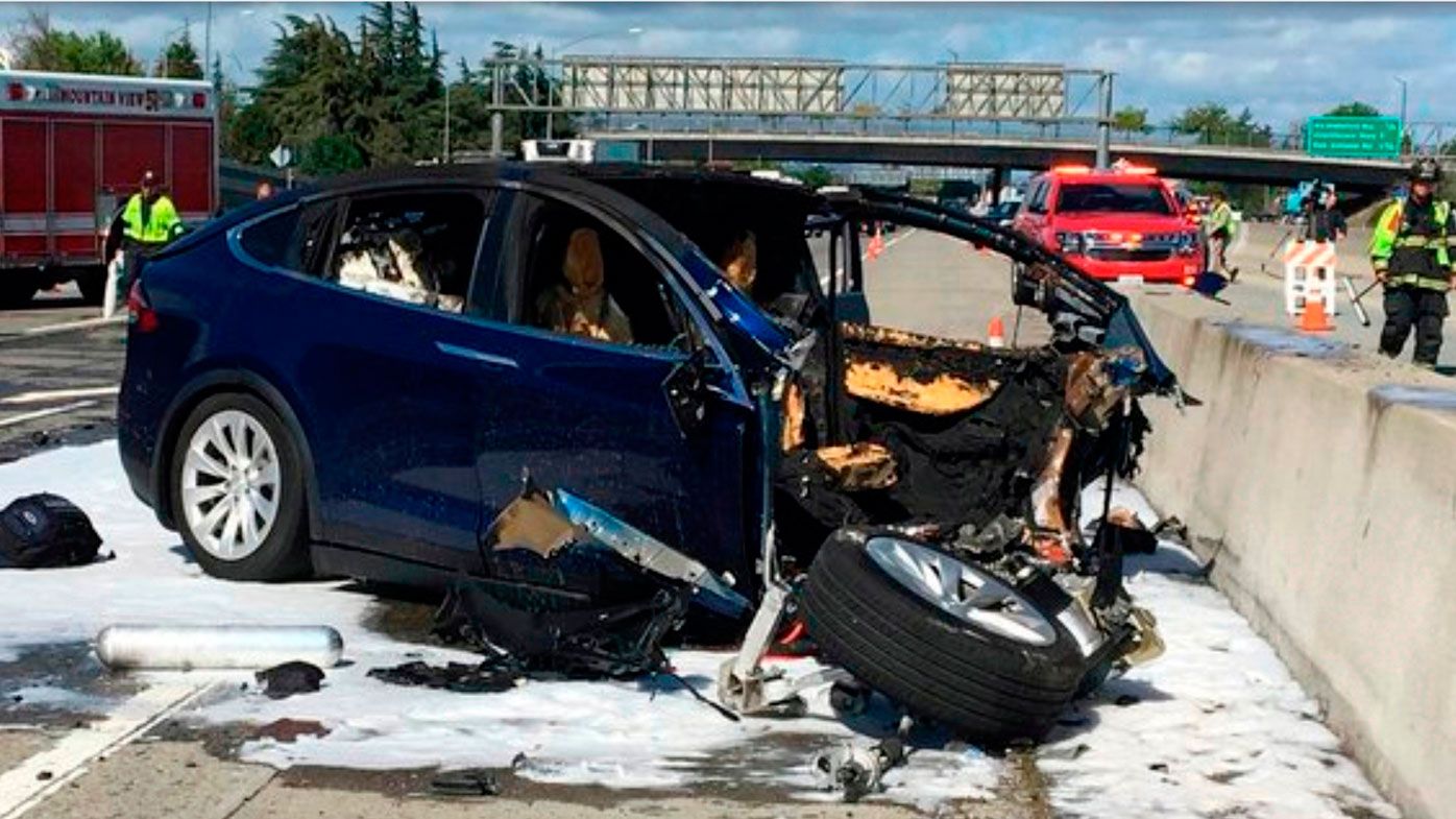 n this March 23, 2018, file photo provided by KTVU, emergency personnel work at the scene where a Tesla electric SUV crashed into a barrier on U.S. Highway 101 in Mountain View, Calif. Federal investigators say the Tesla using the companyâs semi-autonomous driving system accelerated just before crashing into a California freeway barrier, killing its driver. The National Transportation Safety Board issued a preliminary report Thursday, June 7, on the crash. (KTVU via AP, File)