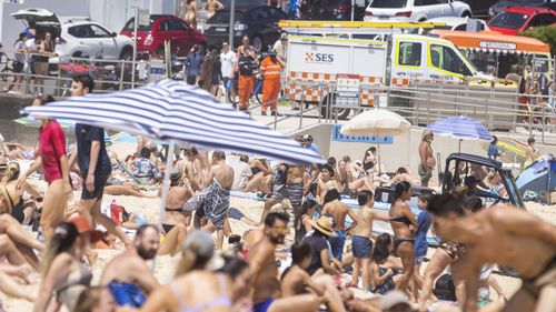 Crowds of people headed to Bondi Beach, despite being warned to stay our of the ocean. An SES van was parked nearby. The Nutri-Grain IronMan & IronWoman Series, was cancelled.