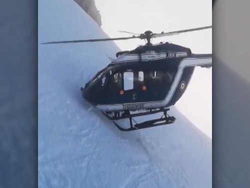 The pilot places the nose of the chopper into the side of the mountain with the blades rotating just millimetres from the snow as the dramatic rescue is performed.