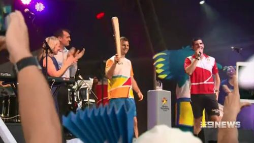 Boxer Jeff Horn carries the Queen's Baton at South Bank in Brisbane. (9NEWS)