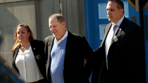 Weinstein leaves the New York police precinct in handcuffs. (AAP)