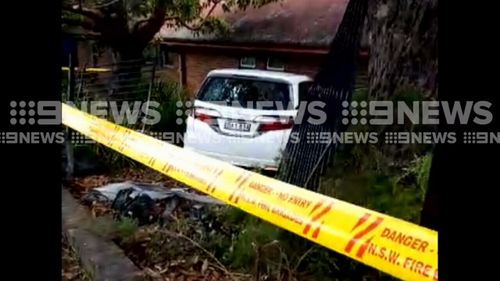 Police have arrested one person and are searching for another after a car crashed through the fence of a Sydney school.