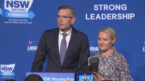 Outgoing NSW Premier Dominic Perrottet giving his concession speech, joined on stage by wife Helen.
