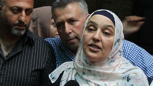 Mahmoud Hrouk's mother Maha Dunia (centre) speaks to the media outside the NSW Supreme Court. (AAP)
