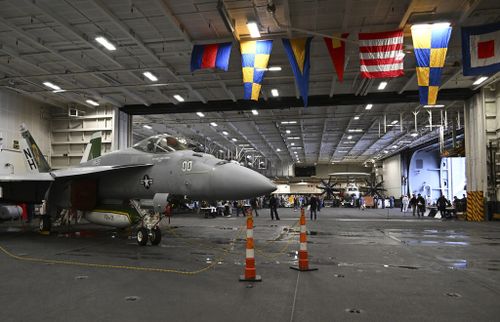 An F-18 fighter aircraft sits in the hanger of the Theodore Roosevelt (CVN 71), a nuclear-powered aircraft carrier, anchored in Busan Naval Base in Busan, South Korea Saturday, June 22, 2024