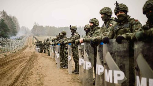 Soldiers from the Polish Armed Forces patrol the Belarus-Polish border.