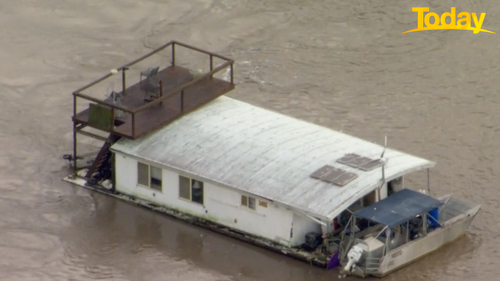 The large houseboat has a smaller boat attached to the back. The barges are used for oyster-farming and are worth 'quite a lot of money'.