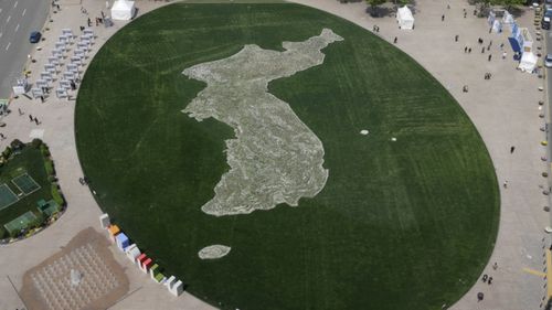 A map of Korean Peninsula made with flowers is seen at Seoul Plaza ahead of the summit. (AAP)