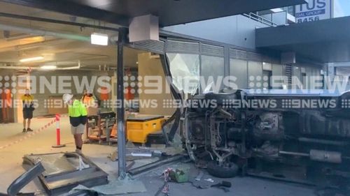 Car crashes into Gold Coast shop, man on the run