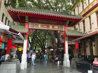 Sydney, Australia - November 5, 2015: People walking passed the gates of Sydney's Chinatown.