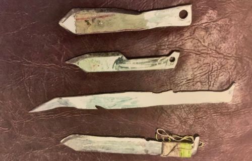 More than a dozen handcrafted knives that were discovered when police raided a shed.