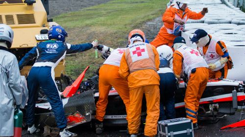 Emergency crews rush to the unconscious Bianchi's aid following the collision. (AAP)