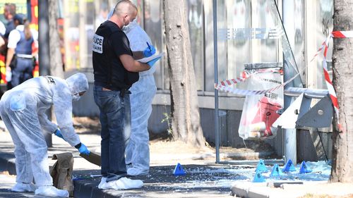 Forensic police search the bus shelter where a car crashed in the town of Marseille, France. (AFP)