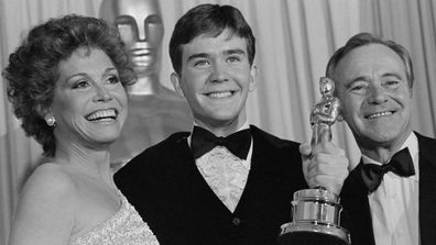 Timothy Hutton holds up his Oscar with presenters Mary Tyler Moore and Jack Lemmon (right), after he was awarded the Best Performance by an Actor in a Supporting Role at the 53rd Annual Academy Awards here March 31.