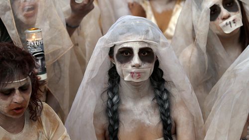 Women dressed to depict "La Llorana" or "The Weeping Woman" perform in a street theatre act to remember the 43 missing students from the Isidro Burgos rural teachers college. The 43 students at the teachers' college of Ayotzinapa disappeared in September 2014 and have not been heard from since they were taken by local police in in the city of Iguala in southern Guerrero state.