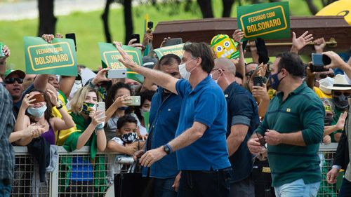 Brazil's president Jair Bolsonaro has been greeting crowds of supporters as the pandemic worsens in his country.