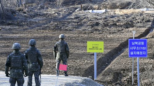 outh Korean soldiers stand at Arrowhead Ridge, a site of fierce battles in the 1950-53 Korean War, to build a tactical road across the Military Demarcation Line.