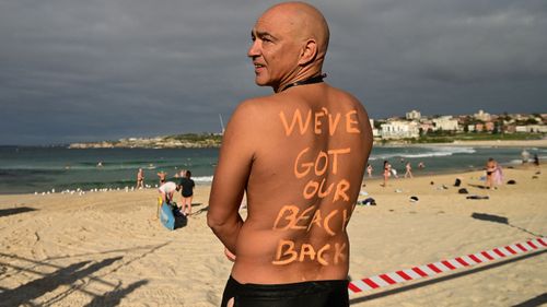 David Wesson poses for a photo as Bondi Beach reopens for exercise to the public after closing following an outbreak of coronavirus (Joel Carrett).