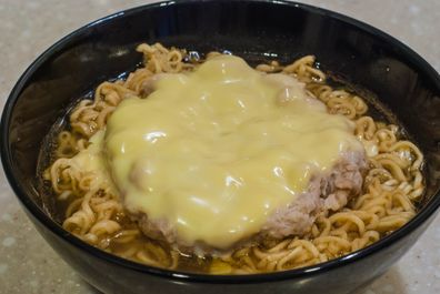 fusion food mixed instant noodle with pork and cheese