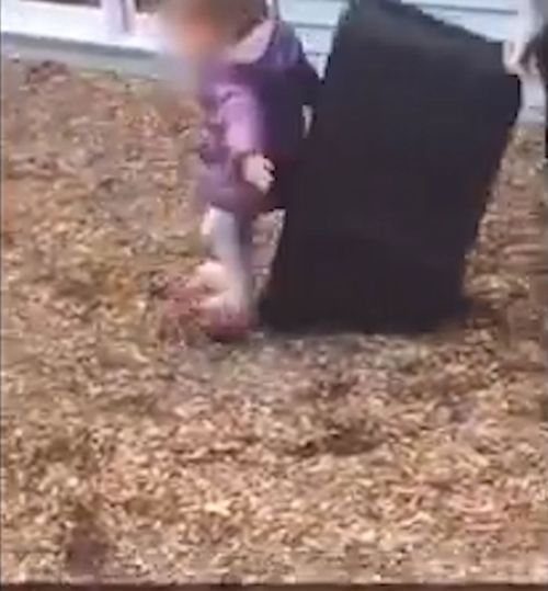 The crying child attempts to stand up before being pushed back down to the ground. (KCCI)