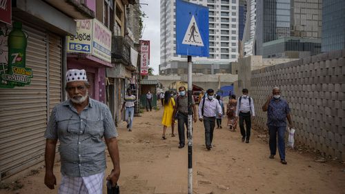 People walk to work in the morning amid fuel shortage in Colombo.