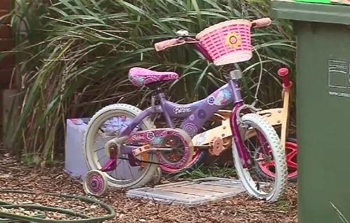 A child's bike sits on the property where Ms Fraser was found dead. Picture: 9NEWS