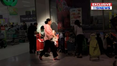 An organised group of shoppers have been caught on camera waiting for baby formula to be stocked, coming in and out of the shop to purchase more.