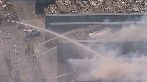 The six alarm fire has tore through a paper storage facility in Sydney's east.