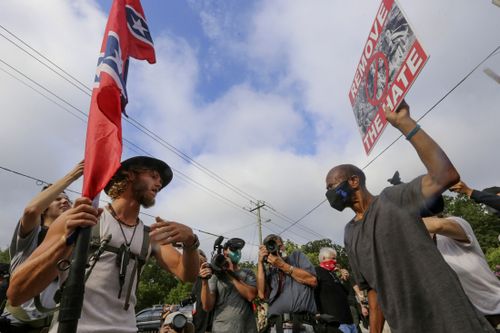 Protestors and counter protestors face off Saturday, Aug. 15, 2020, in Stone Mountain Village