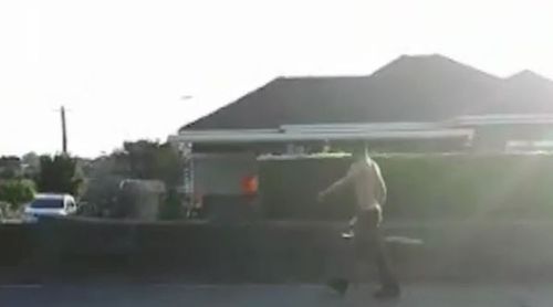 A man is seen pulling a chainsaw out of his car and firing it up. (9NEWS)