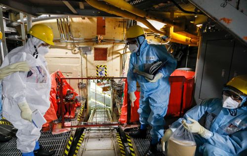 Nuclear experts inspect one of the Fukushima nuclear reactors last year.