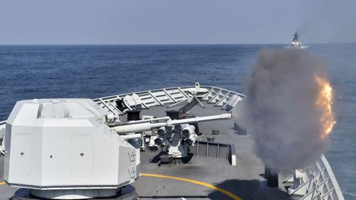 A Chinese frigate opens fire during a live drill.