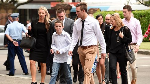 The son of slain police officer Bryson Anderson, Cain, (centre), along with family and supporters, arrives at the Supreme Court in Sydney today.