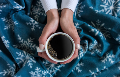 Woman's hands holding black coffee