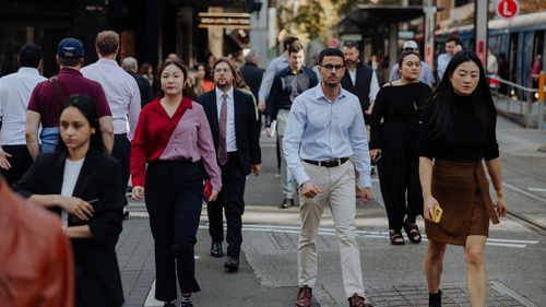Pedestrians and office workers walk through the Sydney CBD. 