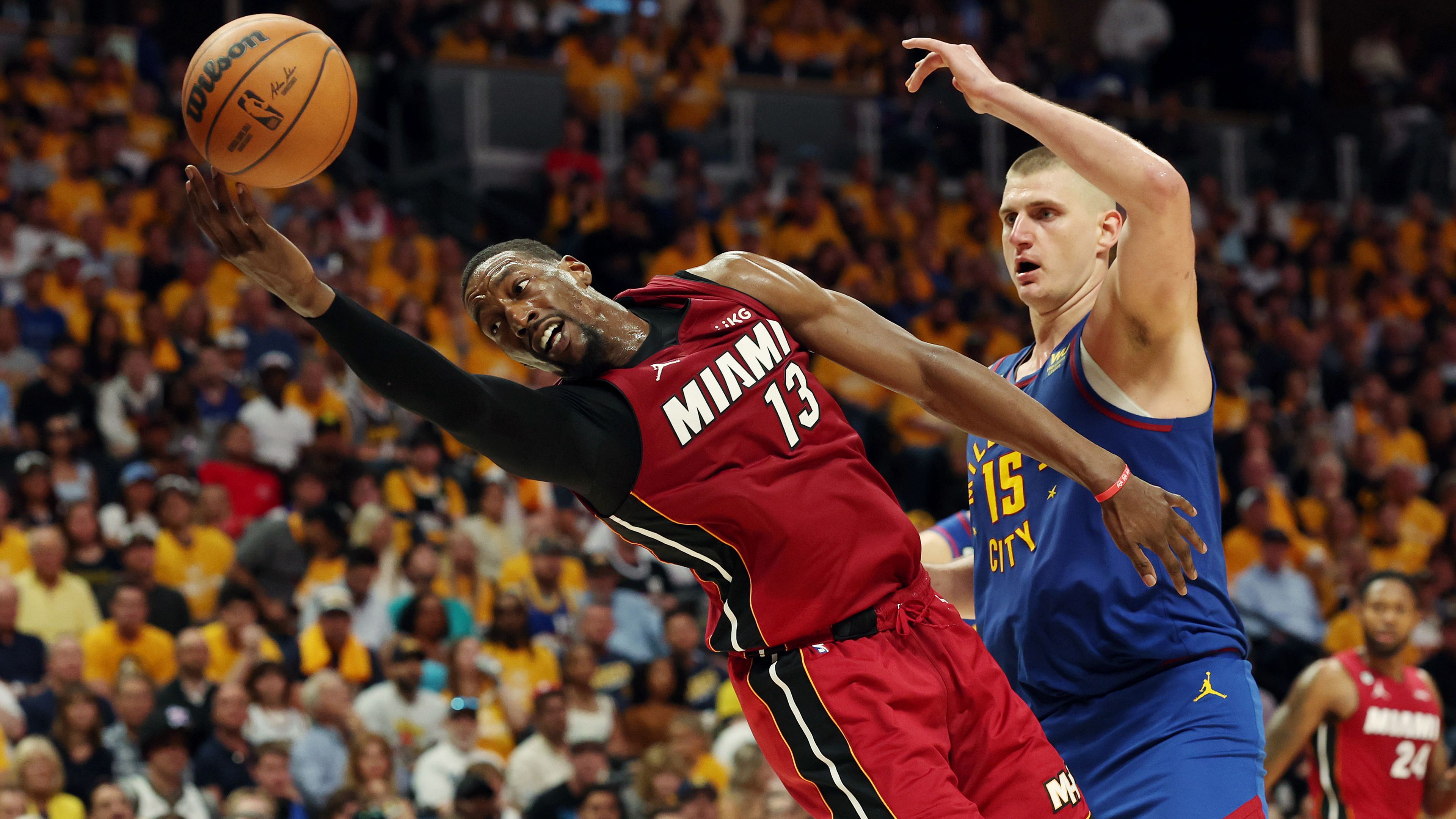 Bam Adebayo of the Miami Heat battles Nikola Jokic of the Denver Nuggets.