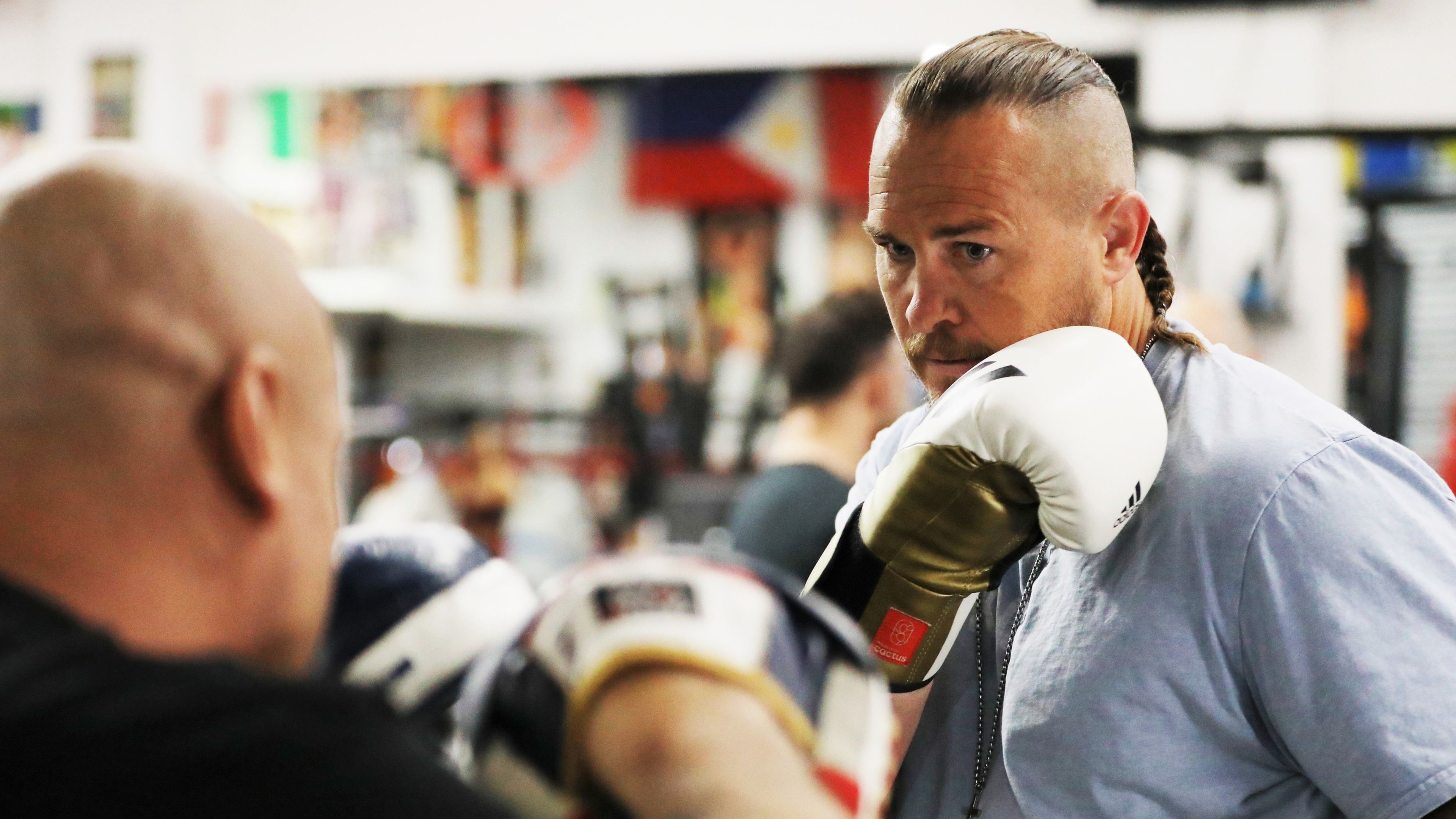 Matt Cooper dons the gloves for a sparring session at the Bondi Boxing Club.